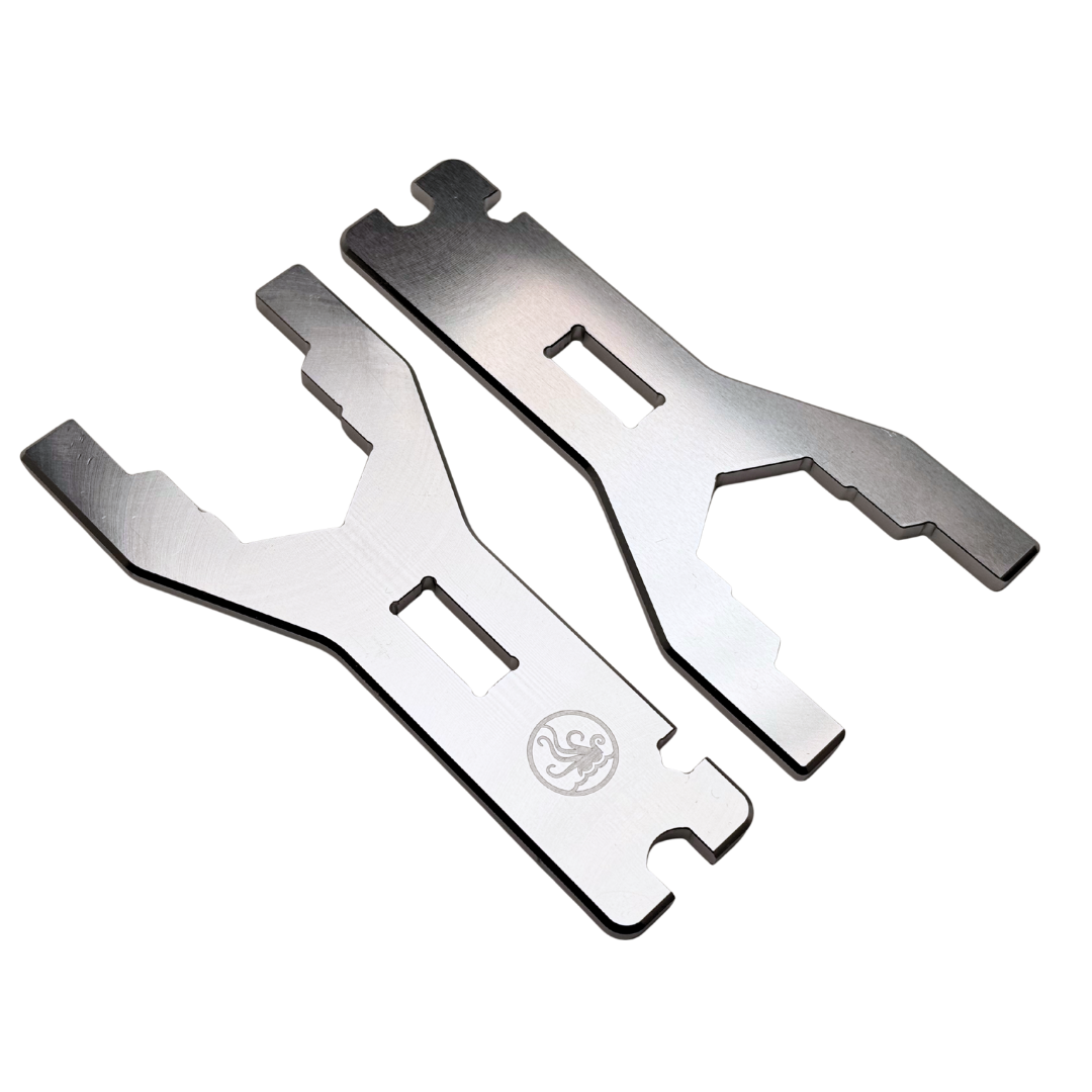 Two metallic tools on a white background