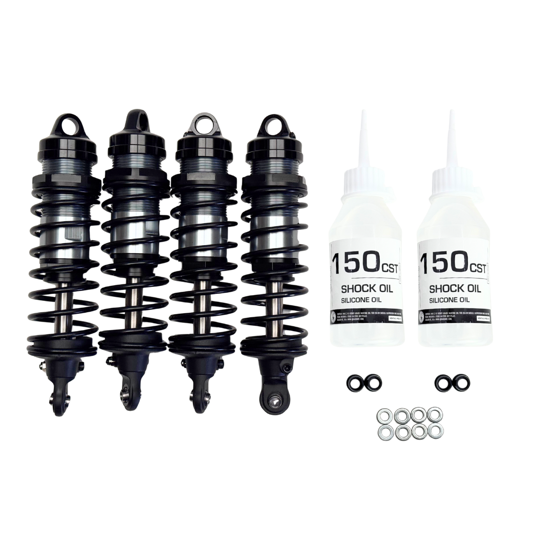 Four shock absorbers and two bottles of shock oil on a white background