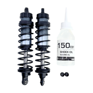 Two shock absorbers and a bottle of shock oil on a white background