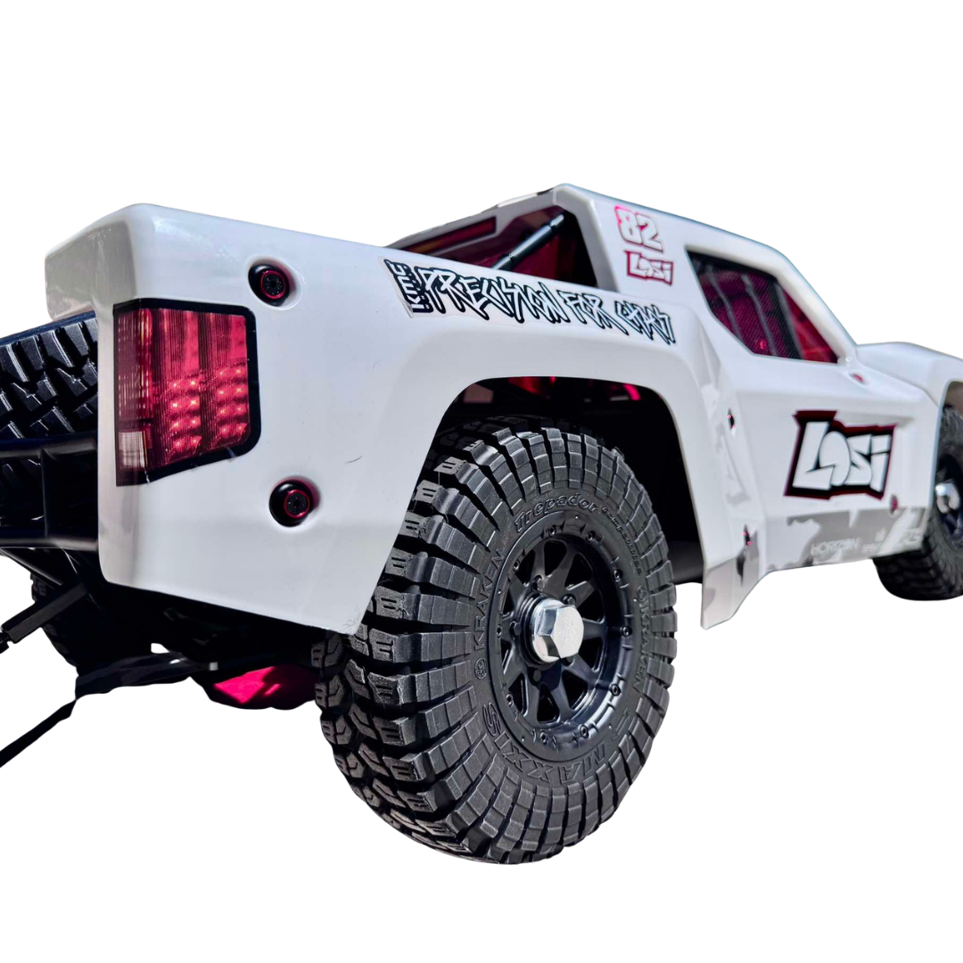 White off-road vehicle with large black tires on a white background