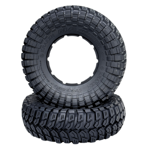 Two black off-road tires with tread pattern on a white background
