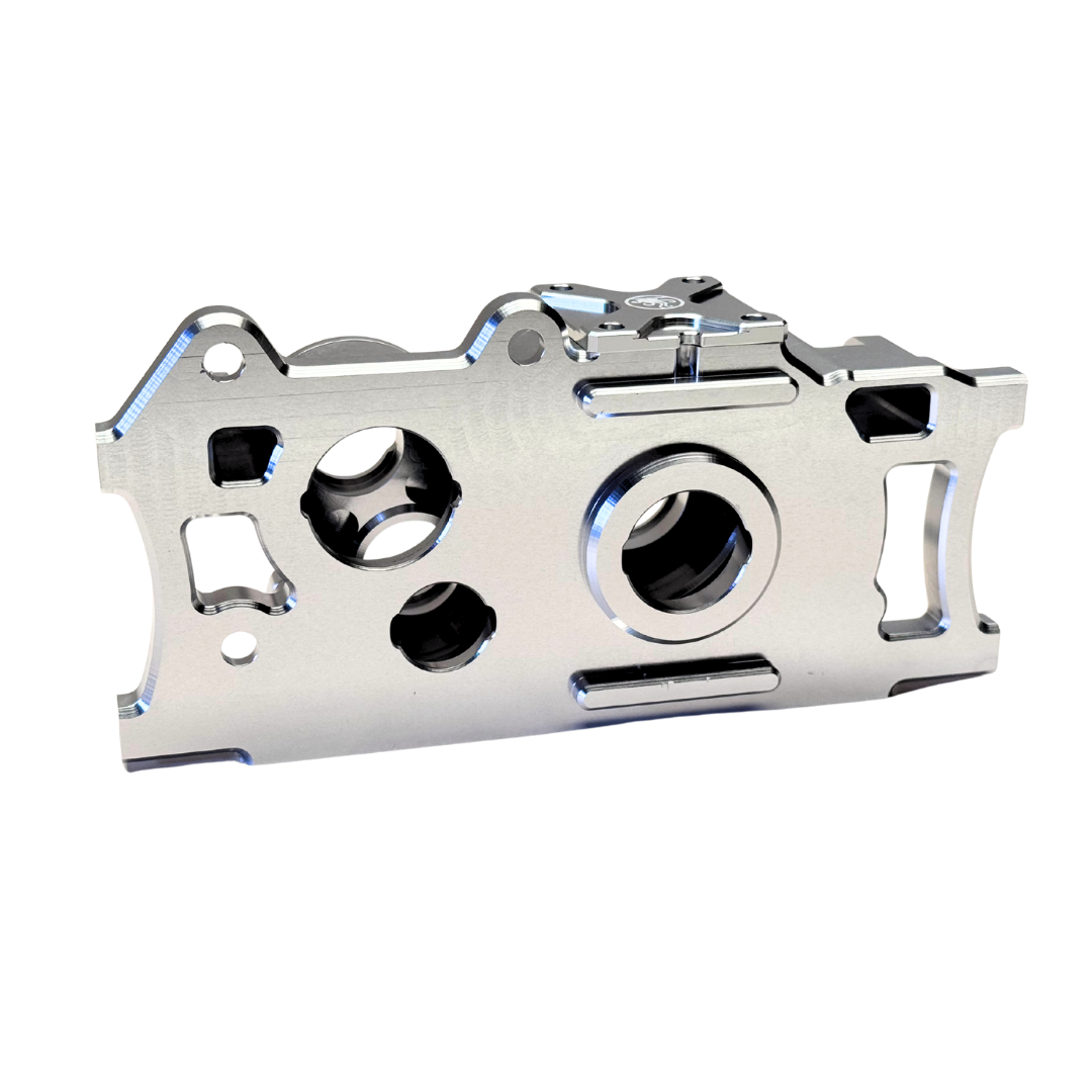 Metallic engine valve cover on a white background