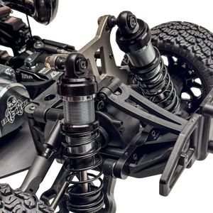 Close-up of a detailed model vehicle suspension system on a white background