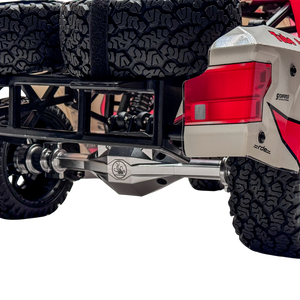 Close-up of an off-road vehicle's rear with visible suspension and tire tread.