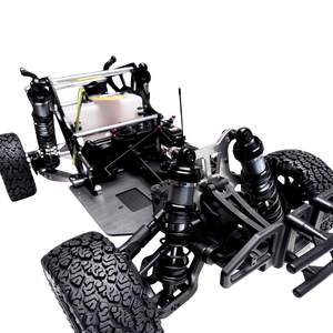 Close-up of a detailed model car chassis with suspension and tires on a white background