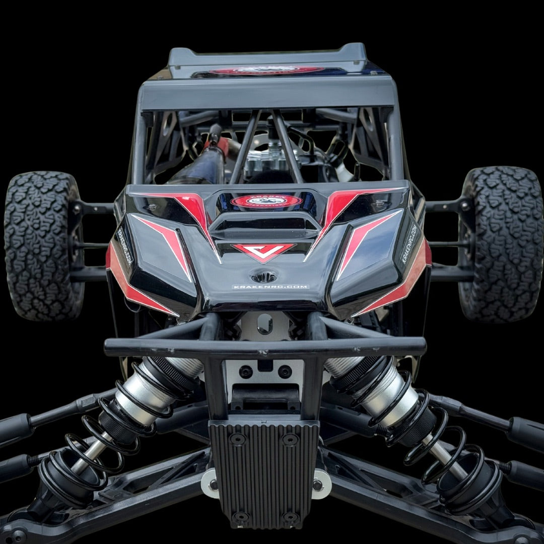 Front view of a black and red off-road vehicle with visible suspension components on a clear background
