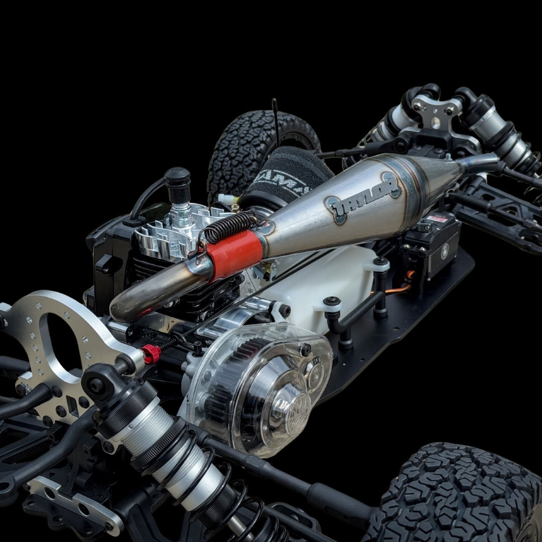 Close-up of a detailed model car chassis with visible branding on a black background