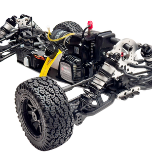 Close-up of a detailed model car chassis with visible components on a white background
