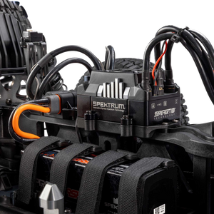 Spektrum electronic speed control unit on a model vehicle with visible branding.