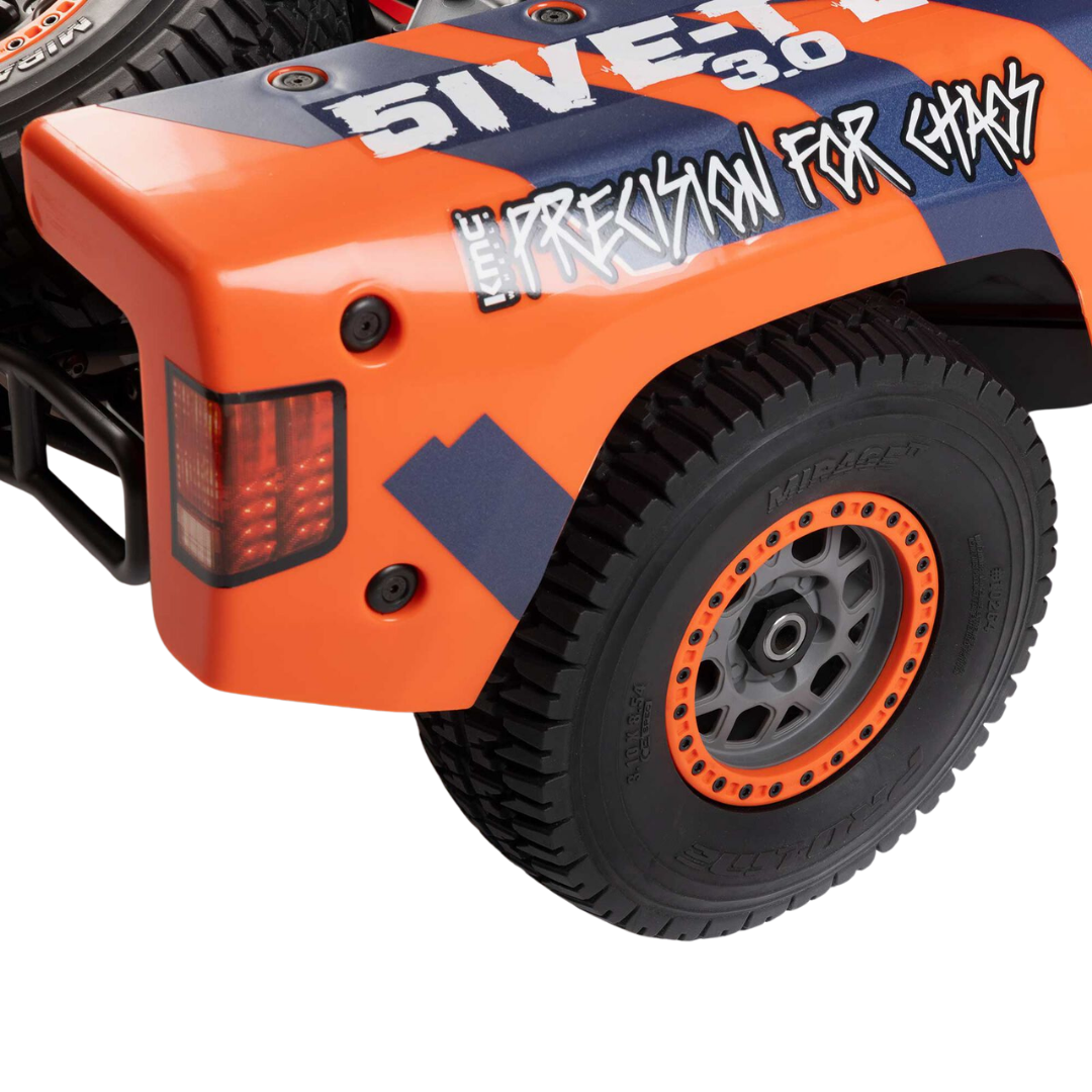 Close-up of an orange and black off-road vehicle with '%IVET' branding on a white background.