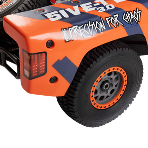 Close-up of an orange and black off-road vehicle with '%IVET' branding on a white background.