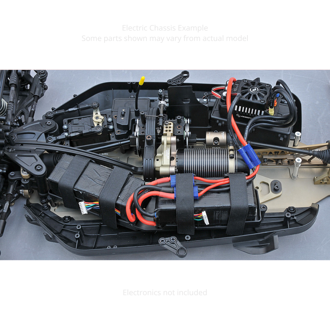 Close-up of an RC car chassis with wiring and components on a gray background