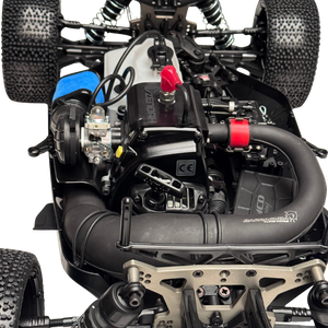 Close-up of a remote control car's engine and mechanical components on a white background