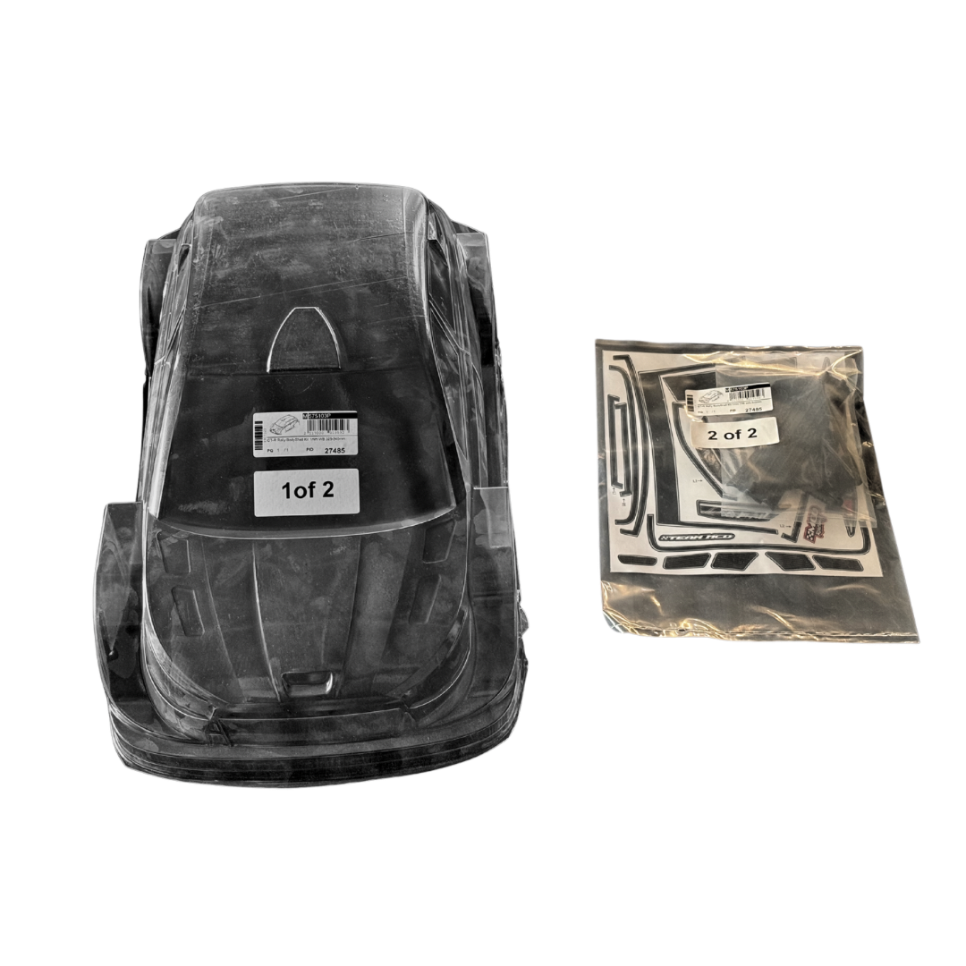 Black plastic car seat base with clear cover and additional packaging on a white background