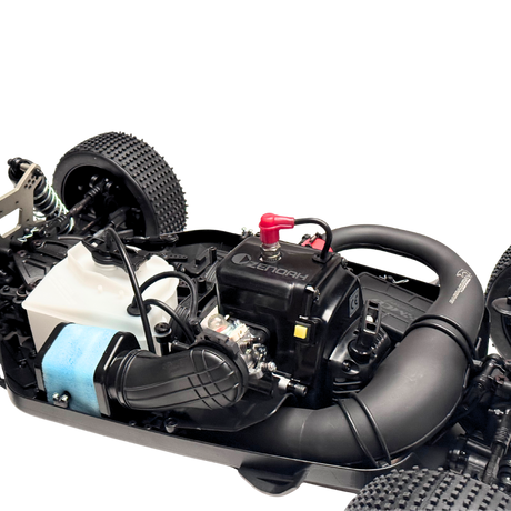 Close-up of a model car engine and chassis on a white background