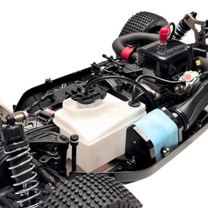 Close-up of a detailed model car chassis with various components on a white background