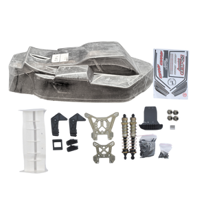 Collection of RC car parts including a body shell, suspension components, and a box on a white background.