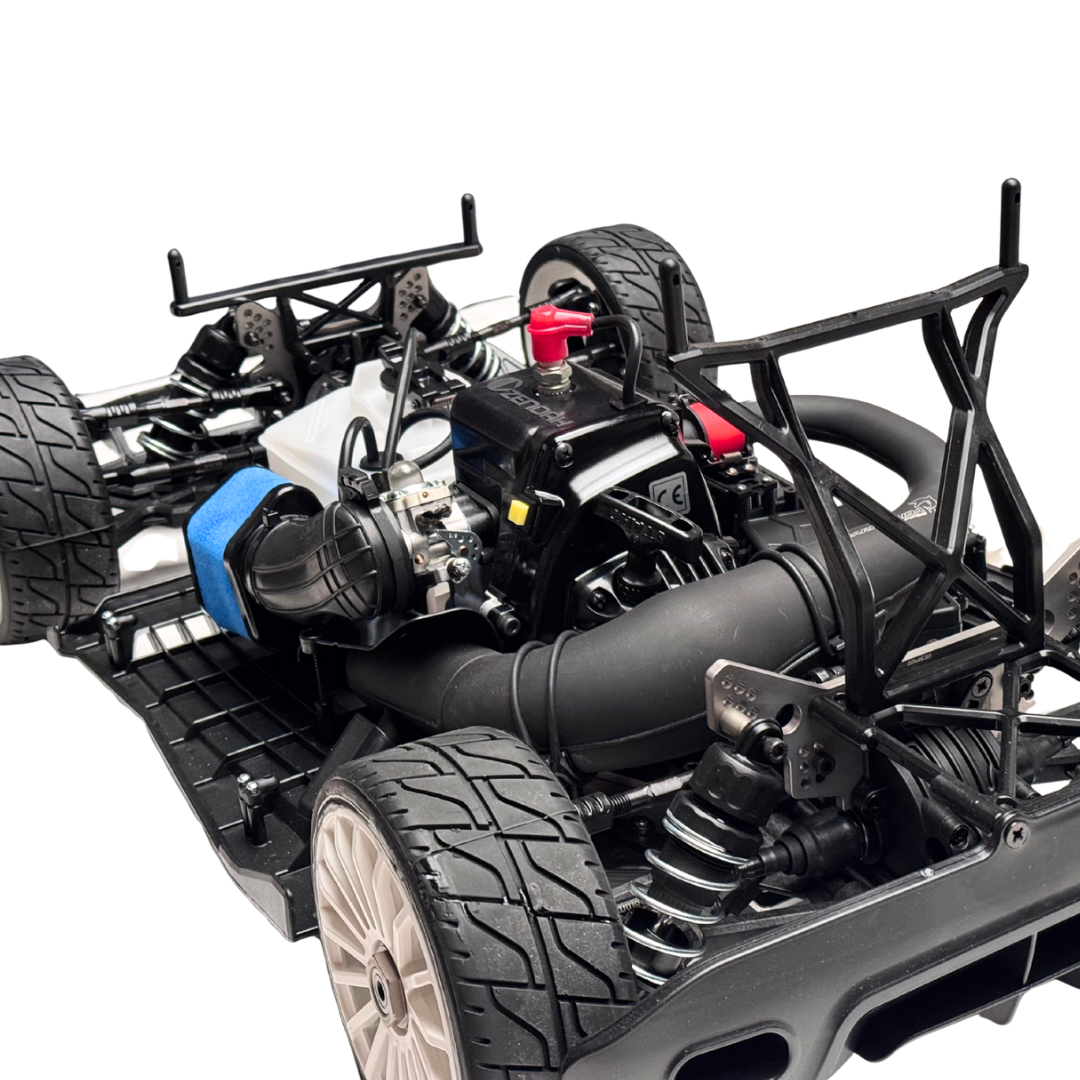 Close-up of a detailed model car chassis with engine and components on a white background