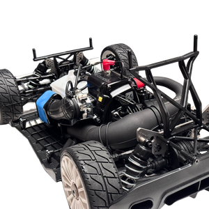 Close-up of a detailed model car chassis with engine and components on a white background