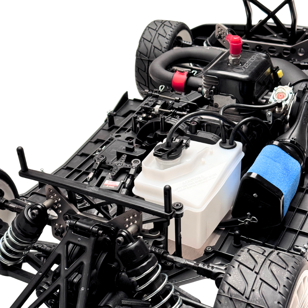 Close-up of a detailed model car chassis with various components on a white background