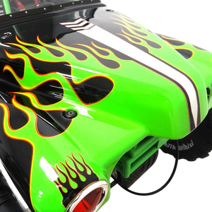 Close-up of a green monster truck with flame design on a white background