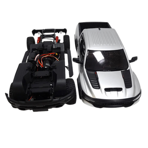 Model of a car chassis and a completed silver car on a white background