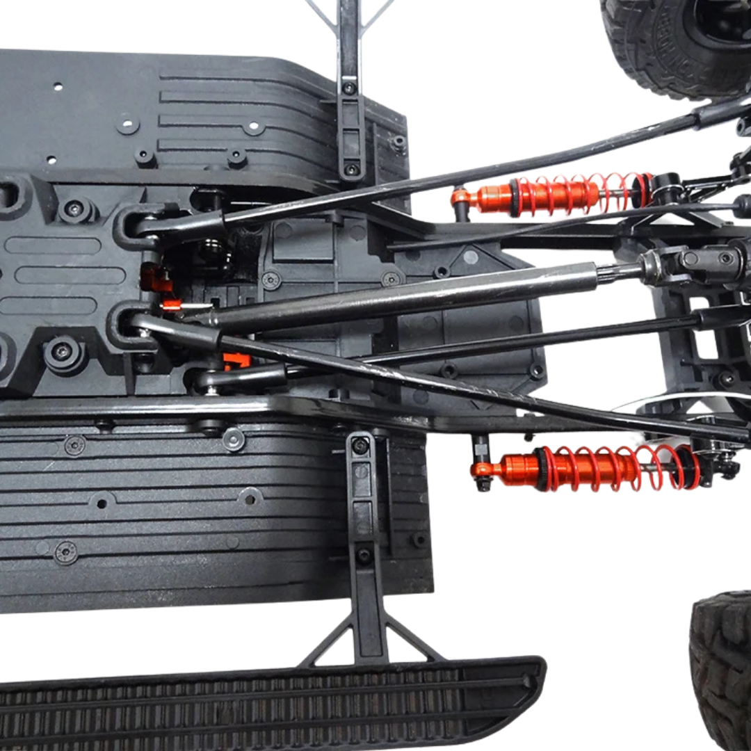 Close-up of a detailed model car chassis with suspension components on a white background