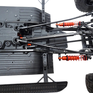 Close-up of a detailed model car chassis with suspension components on a white background