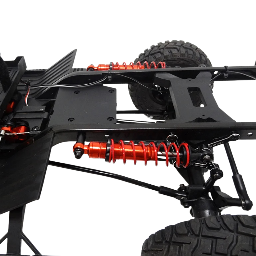 Close-up of a vehicle chassis with red shock absorbers on a white background