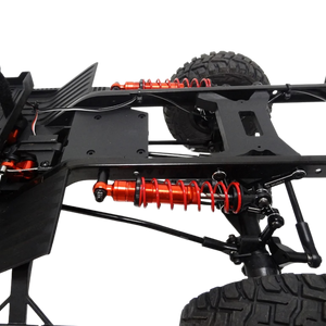 Close-up of a vehicle chassis with red shock absorbers on a white background