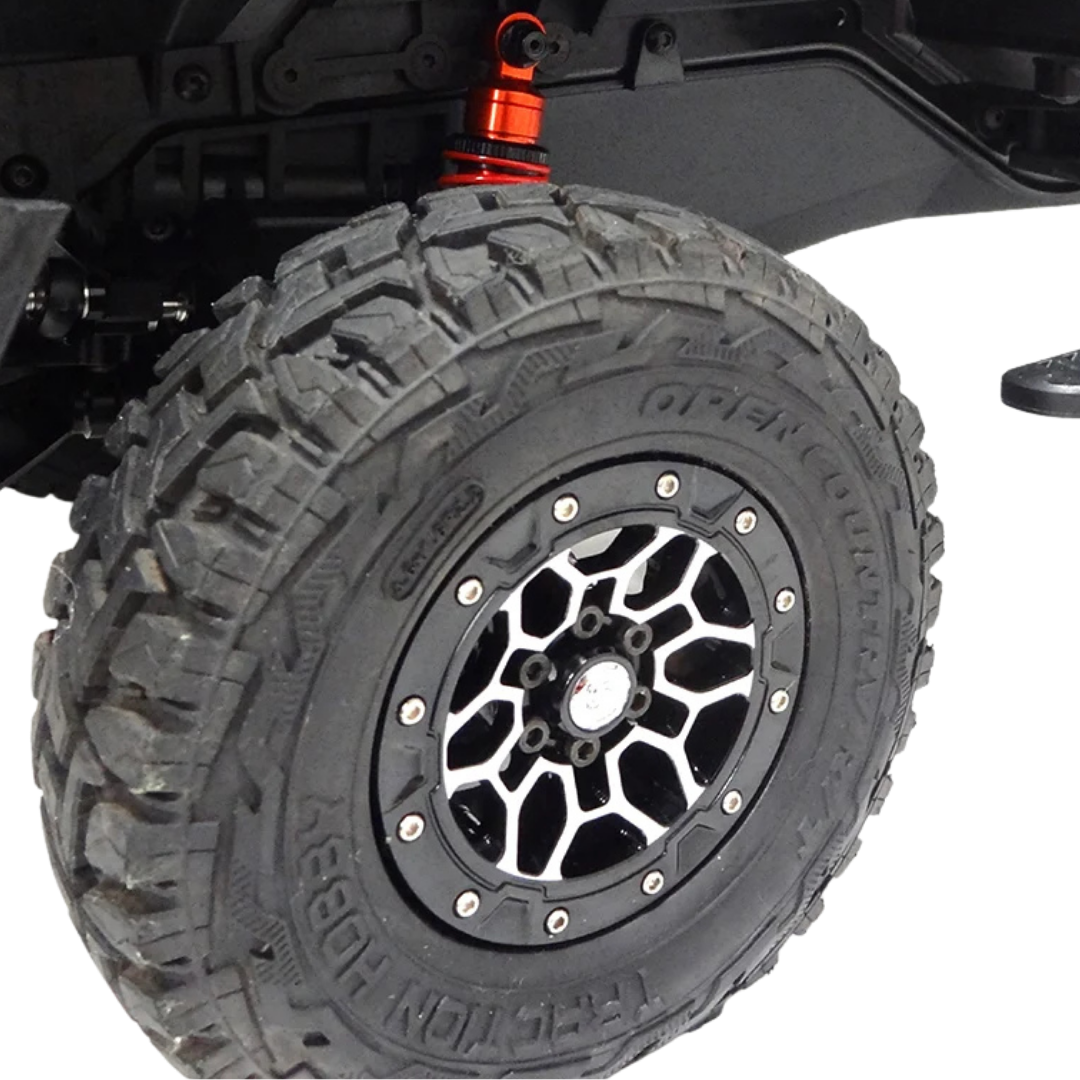 Off-road tire with a black and silver rim on a white background