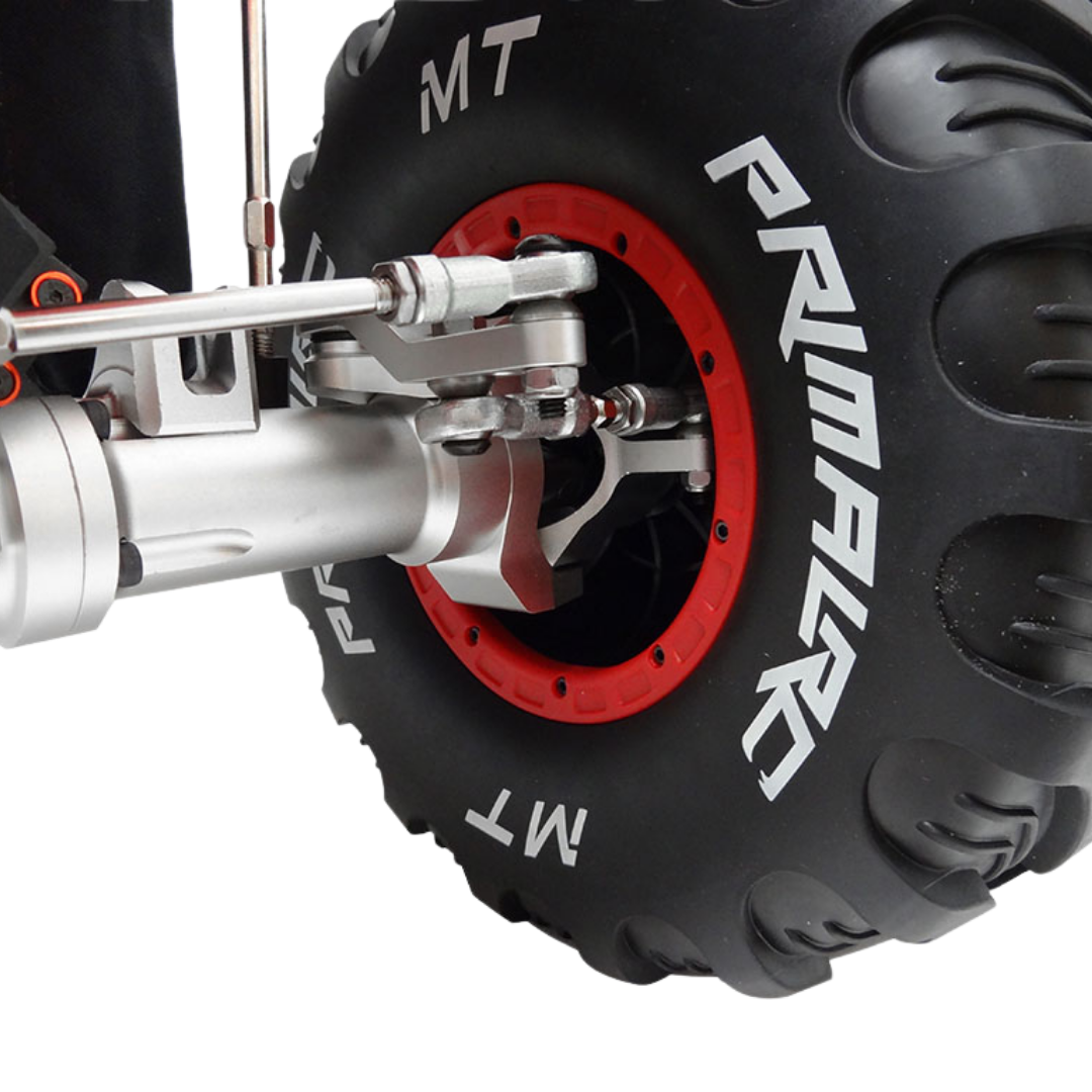 Close-up of a Primal MT tire with red rim and metal suspension on a white background