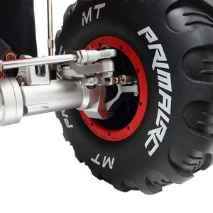 Close-up of a Primal MT tire with red rim and metal suspension on a white background