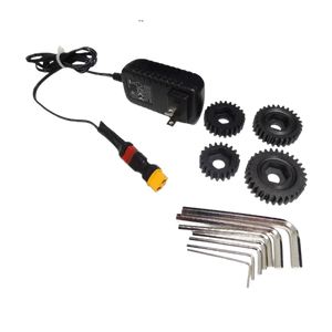 Electrical adapter, gears, and Allen wrenches on a white background