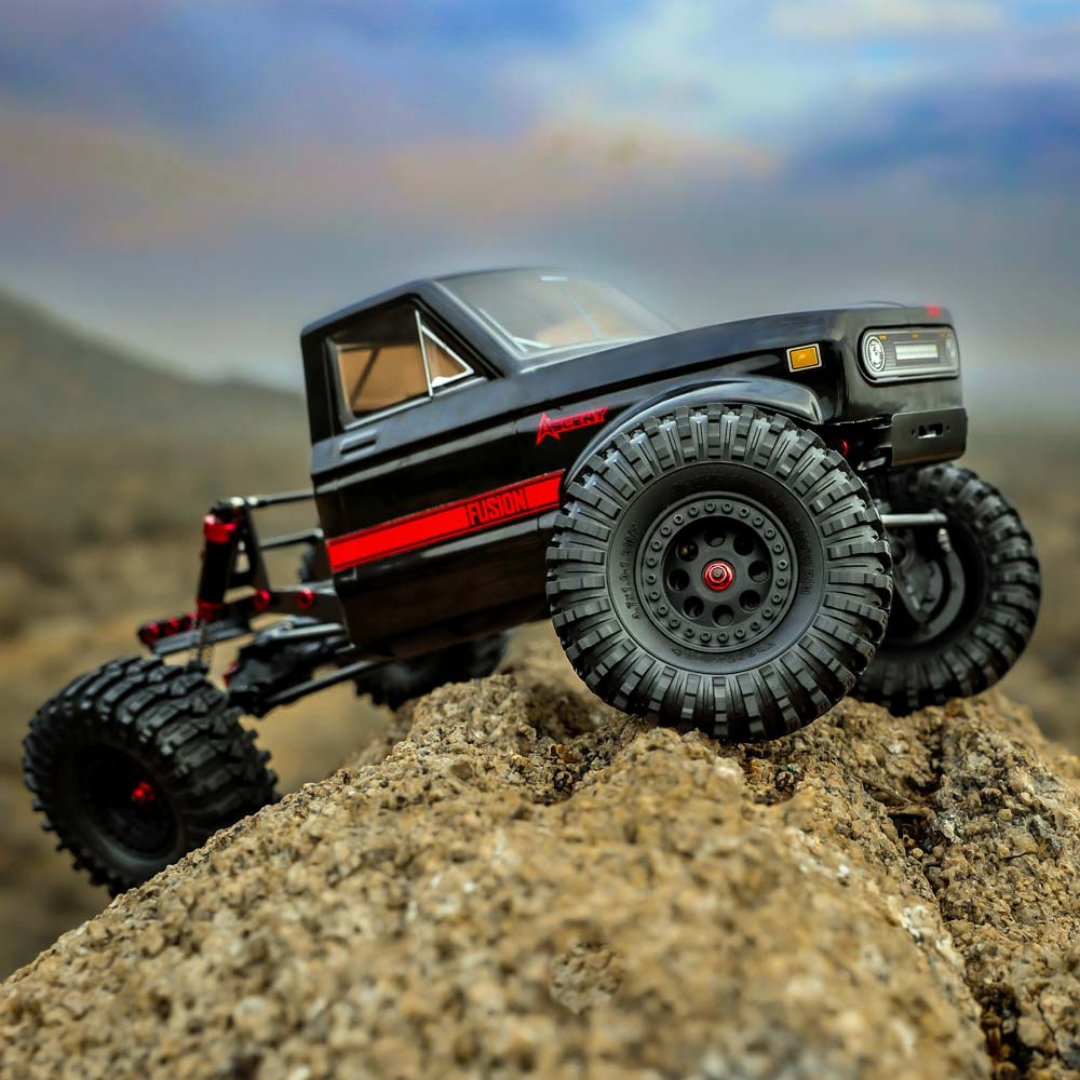 Model off-road truck on a rock with a mountainous background