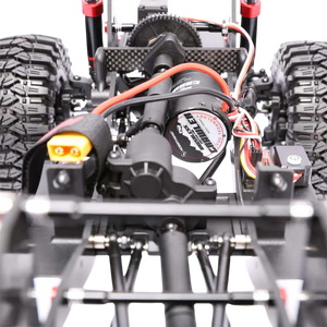 Close-up of a remote control car's suspension system with visible brand name on a white background.