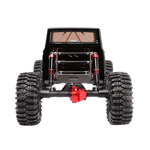 Black off-road vehicle chassis with large tires and red suspension components on a white background