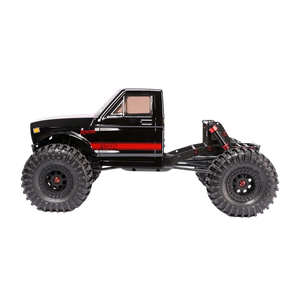Black off-road toy truck with red accents on a white background