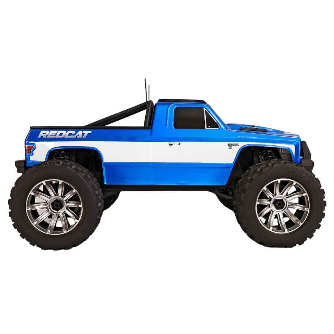 Blue and white RC truck with large wheels on a white background