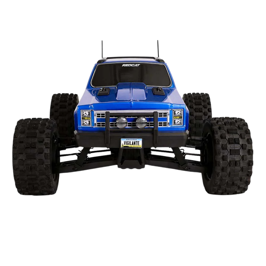 Blue monster truck with large black tires on a white background