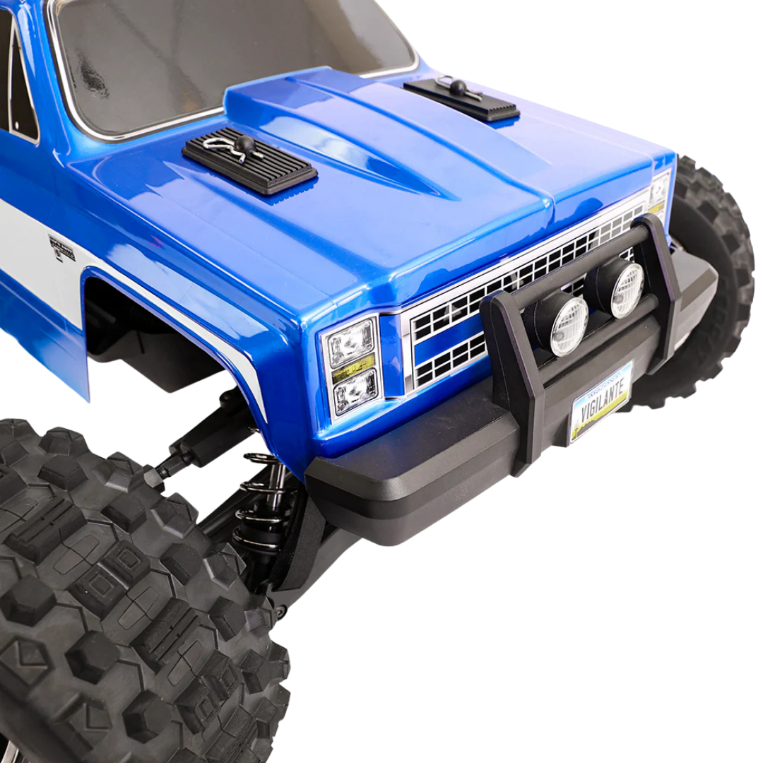 Close-up of a blue off-road vehicle with large black tires on a white background