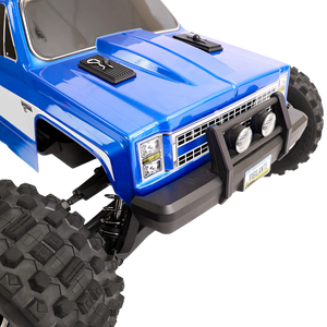Close-up of a blue off-road vehicle with large black tires on a white background