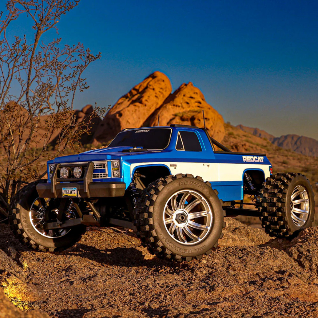 Blue and white remote control truck on a rocky desert landscape