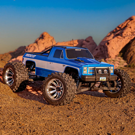 Blue off-road toy truck on a rocky desert landscape