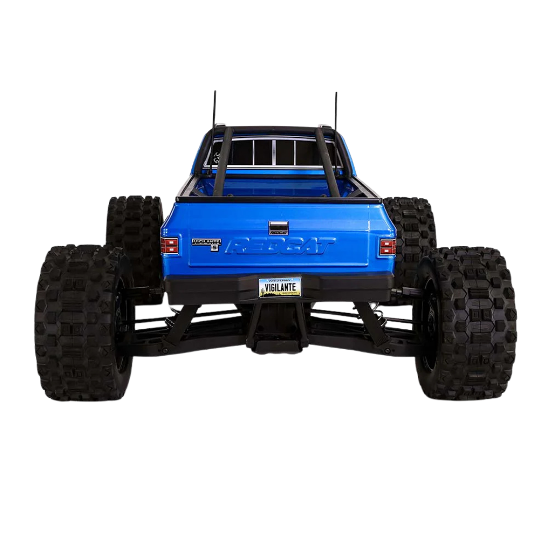Blue monster truck with large black tires on a white background