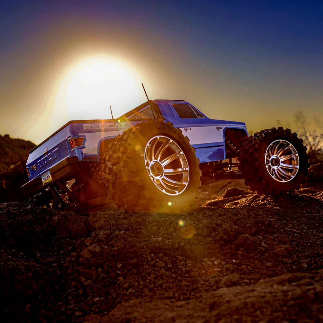Monster truck on a dirt track with a bright light source in the background