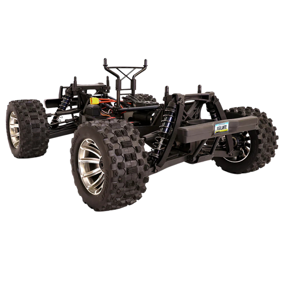 Black off-road RC car chassis with large tires on a white background