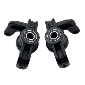 Two black plastic components with bearings on a white background