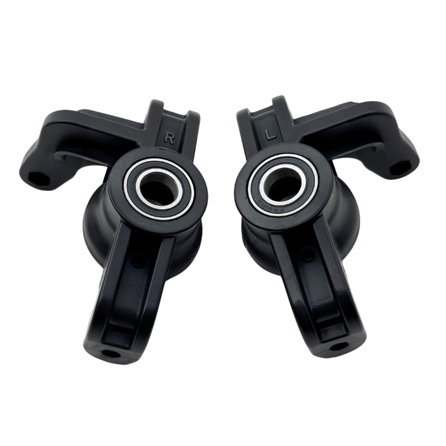 Two black plastic components with bearings on a white background