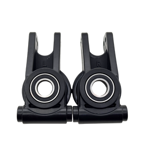 Two black plastic components with bearings on a white background
